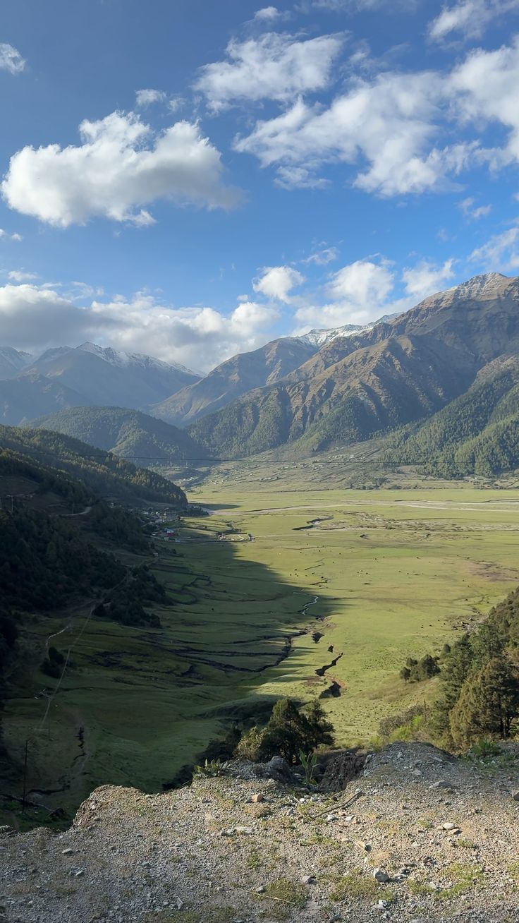 Wide alpine grasslands of Bukipatan with Himalayan mountains